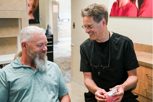 Dr. Johnson showing a patient a model of teeth