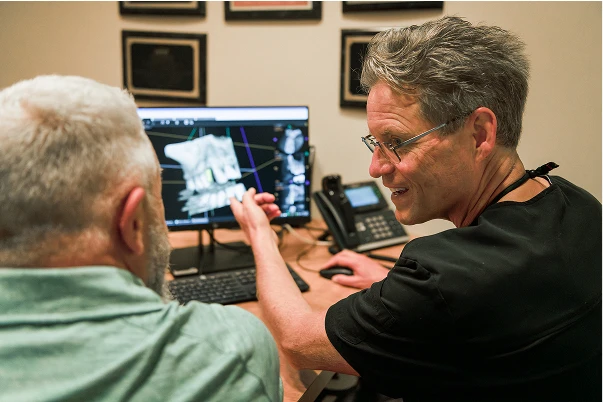 Dr. Johnson showing a patient an xray on the computer