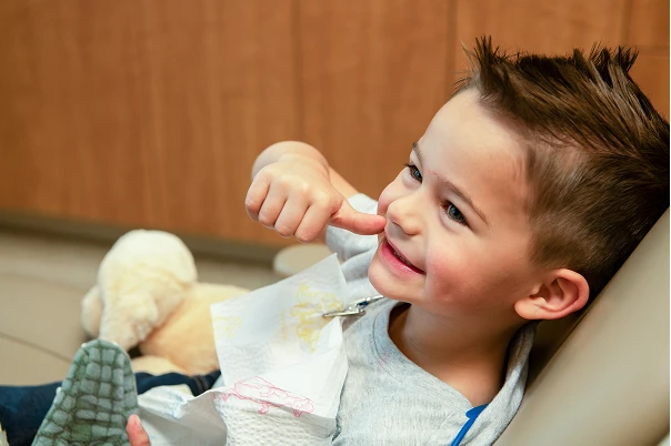 A patient smiling and giving a thumb's up