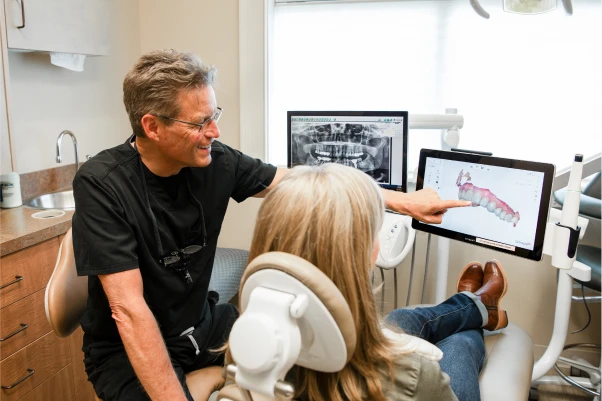 Dr. Johnson showing a patient their teeth scan