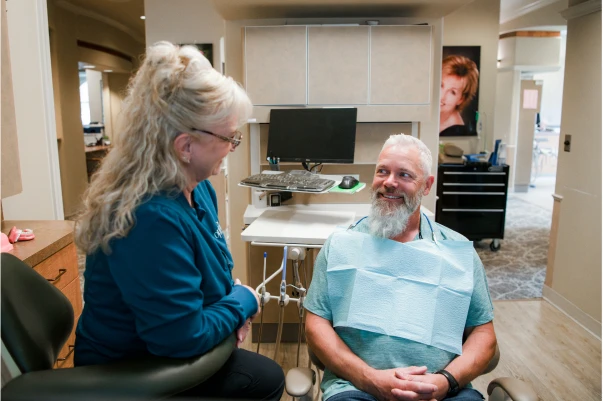 An employee speaking with a patient